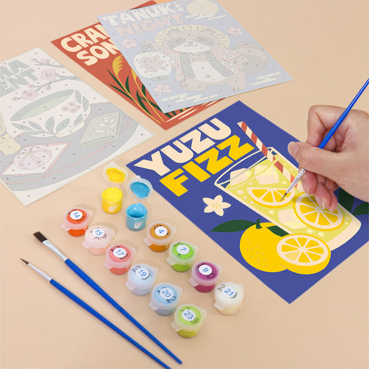 Hand painting a Kyoto Posters mini canvas of a lemon drink poster next to numbered paint pots