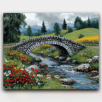 Silent Bridge paint by numbers kit of a stone bridge over a river in a sunlit wildflower meadow