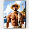 The Lighthouse Keeper paint by numbers kit of a cheerful sailor on a sandy beach beside a lighthouse