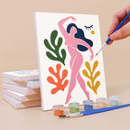 Painting an Abstract Figures mini canvas propped up beside numbered acrylic paints