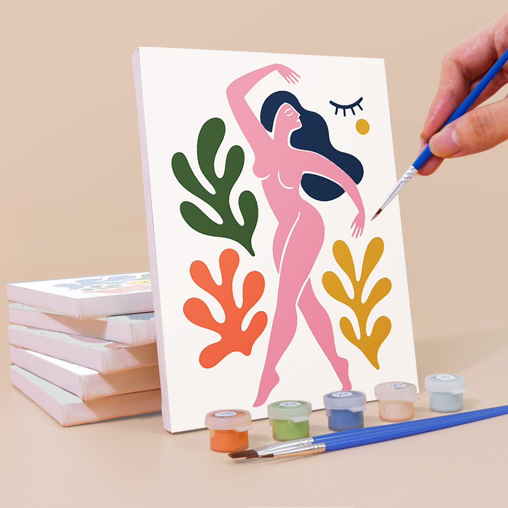 Painting an Abstract Figures mini canvas propped up beside numbered acrylic paints