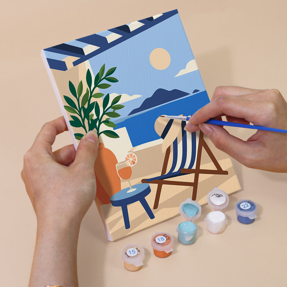 Hand holding an Aegean Daydream mini canvas while painting the details