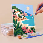 Painting an Aegean Daydream mini canvas propped up beside numbered acrylic paints