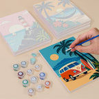 Painting one of the Aloha Horizons designs next to a stack of mini canvases