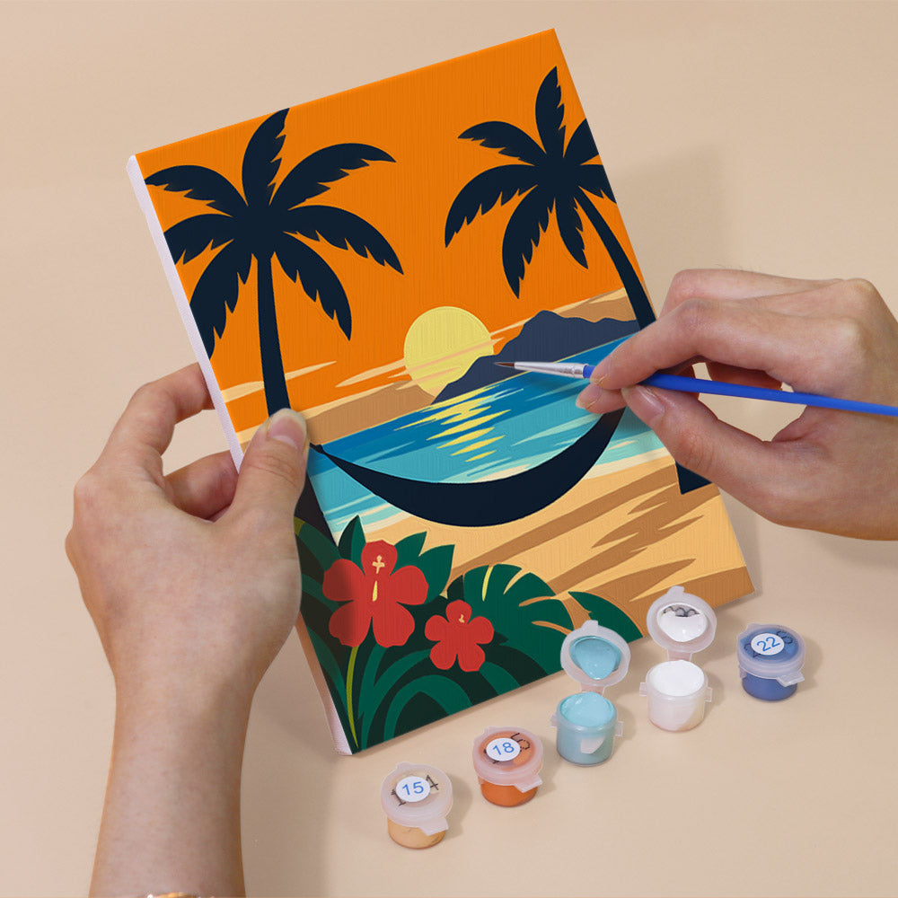 Hand holding an Aloha Horizons mini canvas while painting the details