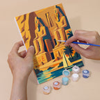 Hand holding an Ancient Egypt mini canvas while painting the details