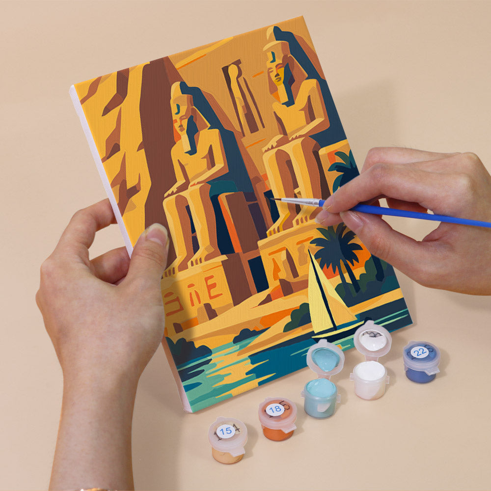 Hand holding an Ancient Egypt mini canvas while painting the details