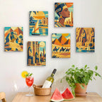 Six finished Ancient Egypt mini paintings hung on a wall above a table