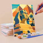 Painting an Ancient Egypt mini canvas propped up beside numbered acrylic paints