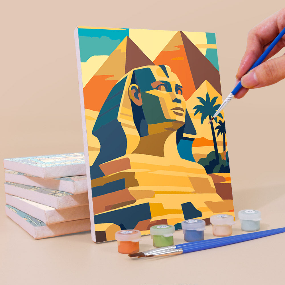 Painting an Ancient Egypt mini canvas propped up beside numbered acrylic paints