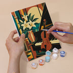Hand holding an Art Deco Elegance mini canvas while painting the details