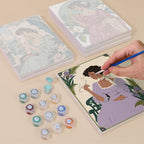 Painting one of the Art Nouveau Muses designs next to a stack of mini canvases