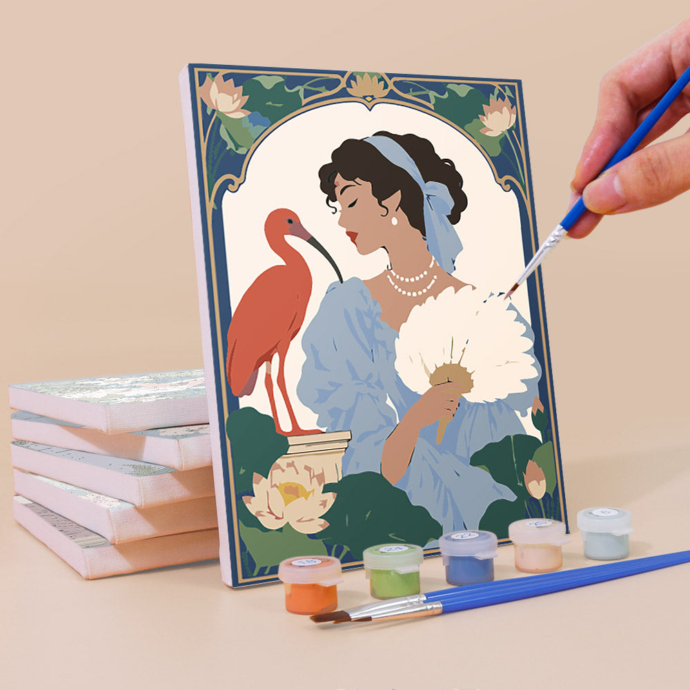 Painting an Art Nouveau Muses mini canvas propped up beside numbered acrylic paints