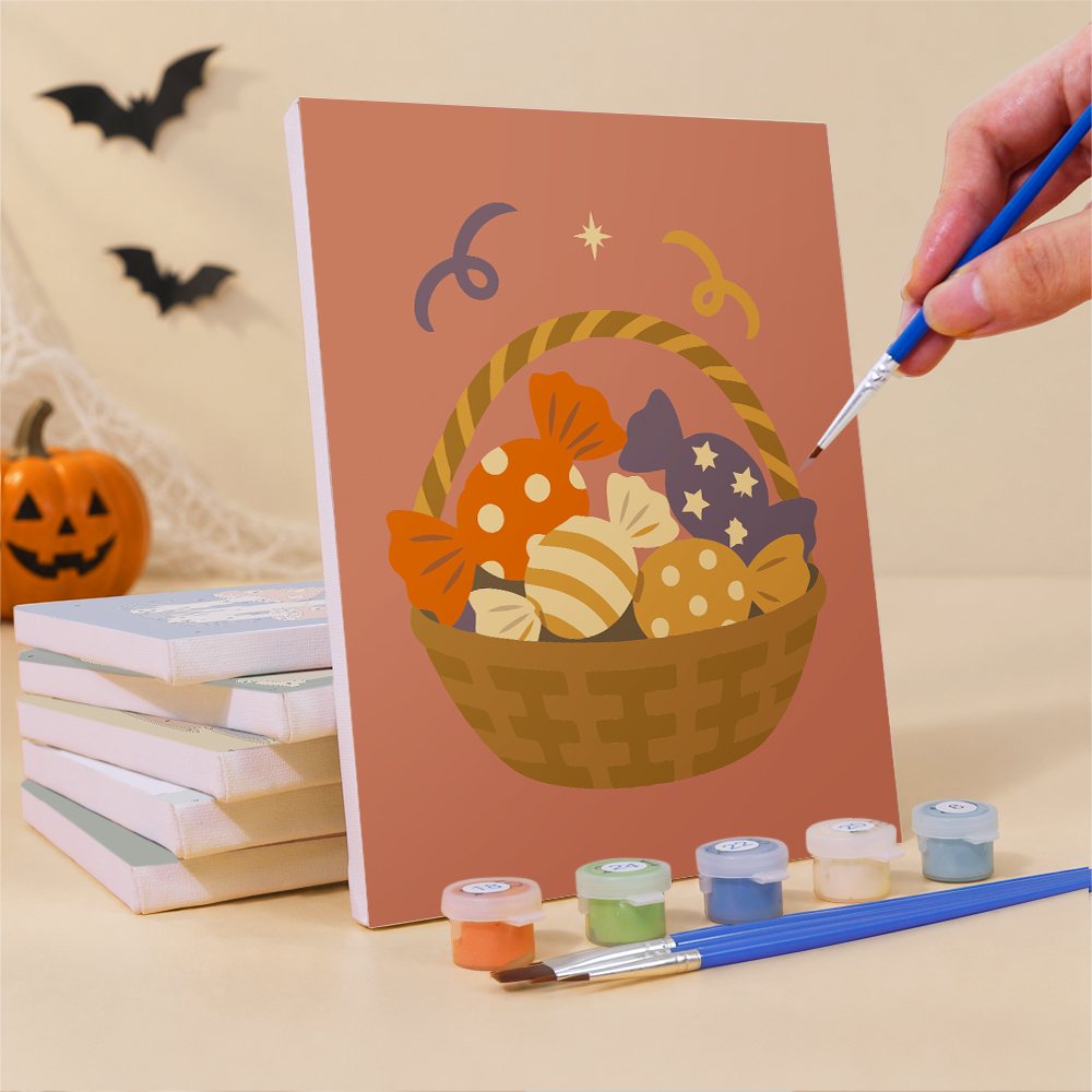 Painting an Autumn Apothecary mini canvas propped up beside numbered acrylic paints