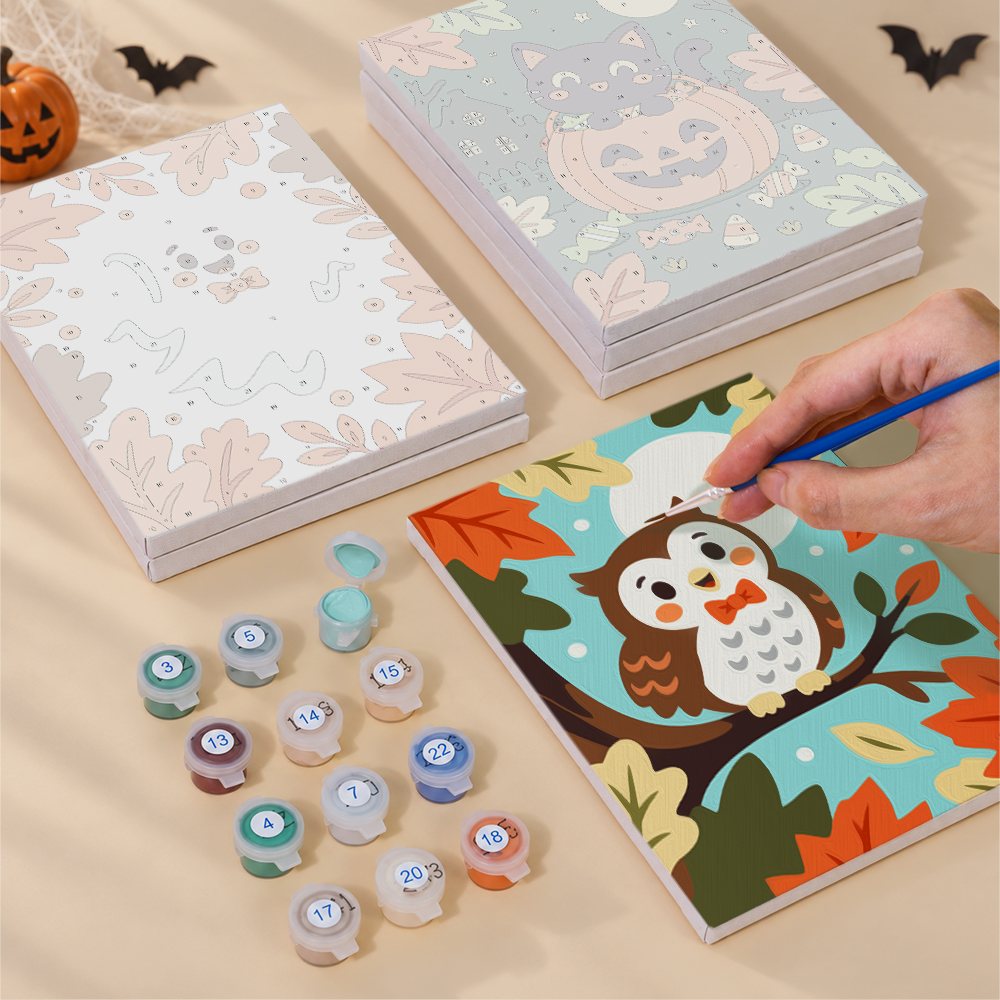 Painting one of the Autumn Critter Costumes designs next to a stack of mini canvases