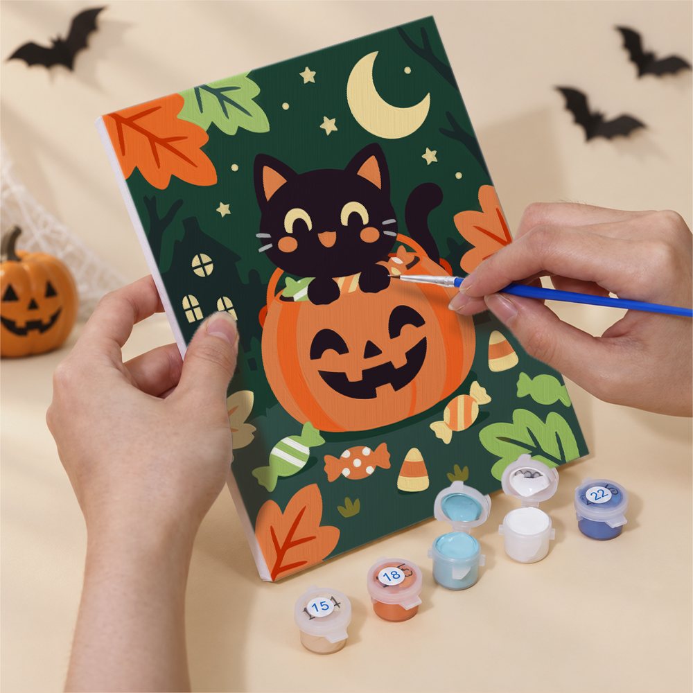 Hand holding an Autumn Critter Costumes mini canvas while painting the details