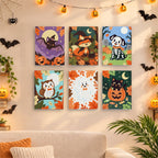 Six finished Autumn Critter Costumes mini paintings hung on a wall above a table