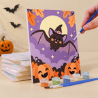 Painting an Autumn Critter Costumes mini canvas propped up beside numbered acrylic paints