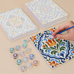 Painting one of the Azulejo Tiles designs next to a stack of mini canvases
