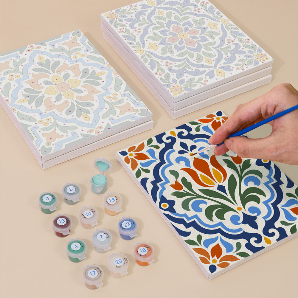 Painting one of the Azulejo Tiles designs next to a stack of mini canvases