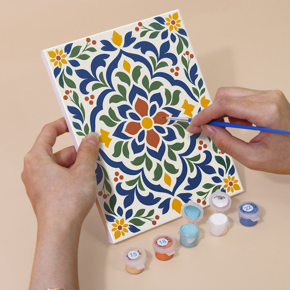 Hand holding an Azulejo Tiles mini canvas while painting the details
