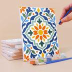 Painting an Azulejo Tiles mini canvas propped up beside numbered acrylic paints