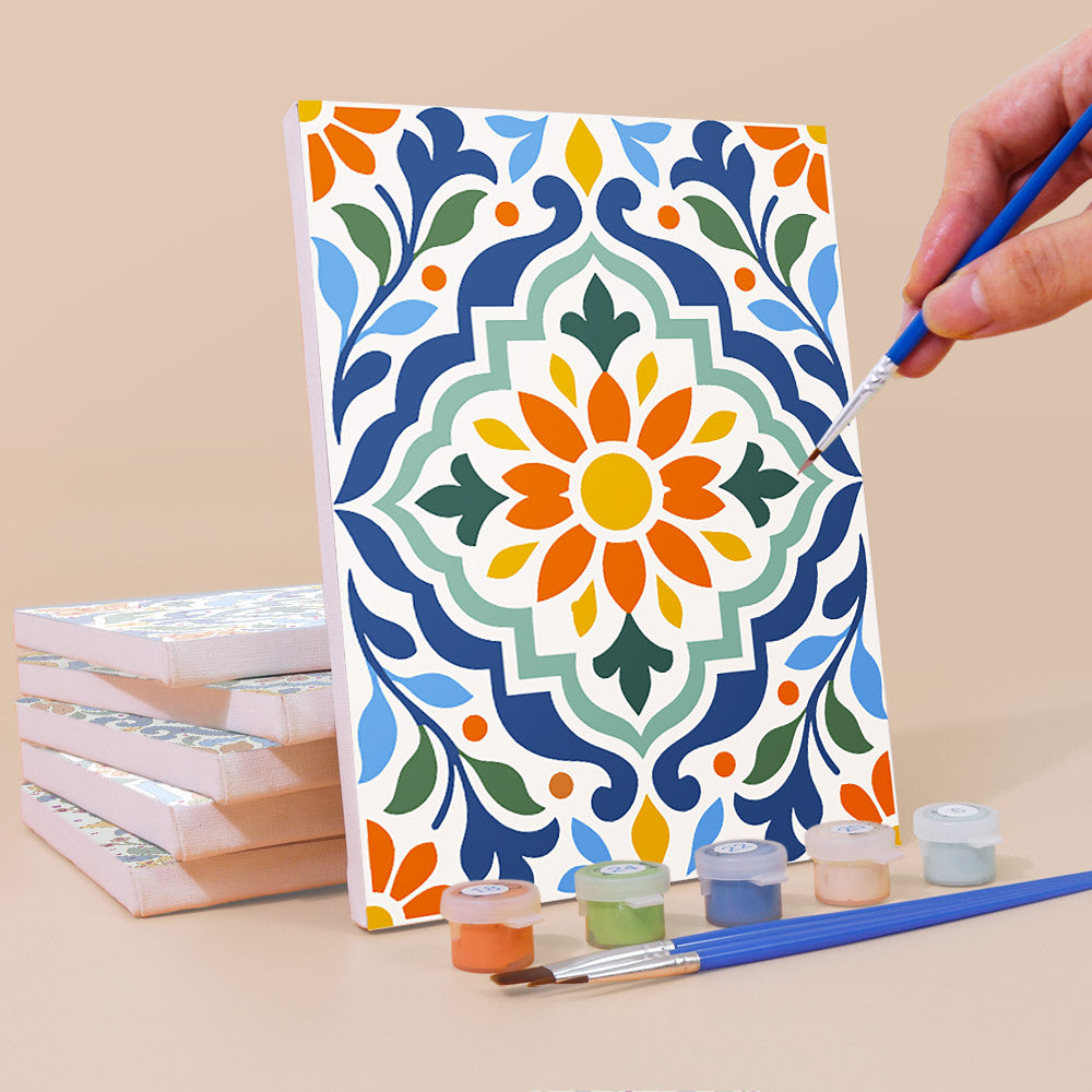 Painting an Azulejo Tiles mini canvas propped up beside numbered acrylic paints