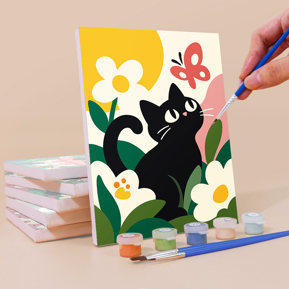 Painting a Black Cat Garden mini canvas propped up beside numbered acrylic paints