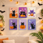 Six finished Black Cat Treats mini paintings hung on a wall above a table