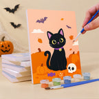 Painting a Black Cat Treats mini canvas propped up beside numbered acrylic paints