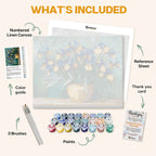 What's included in the Blooming Irises paint by numbers kit: numbered linen canvas, reference sheet, color guide, 24 acrylic paints, 3 brushes and thank you card