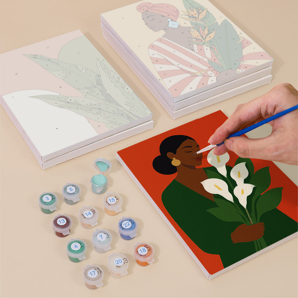 Painting one of the Blooming Muses designs next to a stack of mini canvases