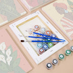 Numbered paint pots and brushes on a pre-stretched Blooming Muses mini canvas