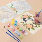 Filling in a Blossom Birds mini canvas with numbered acrylic paints and a fine brush