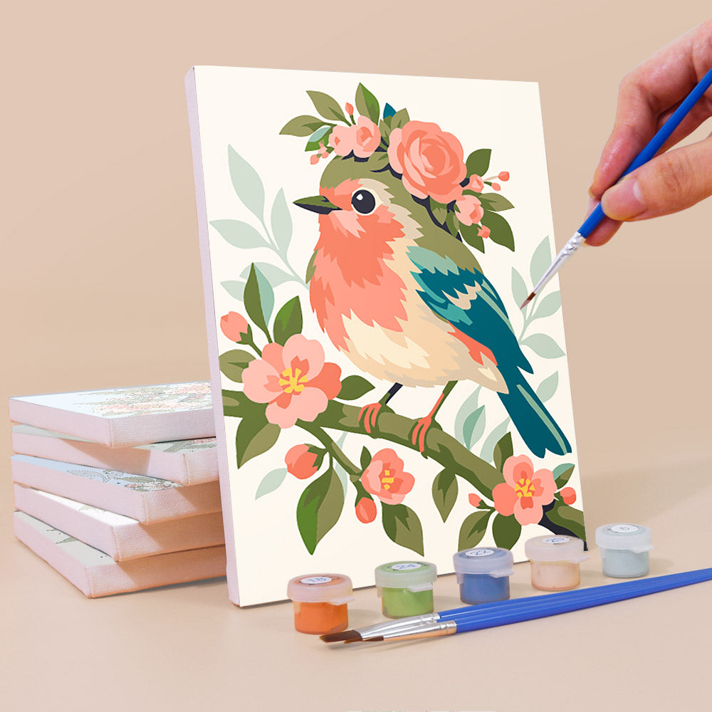Painting a Blossom Birds mini canvas propped up beside numbered acrylic paints
