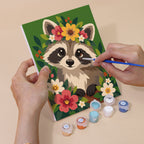 Hand holding a Blossom Critters mini canvas while painting the details