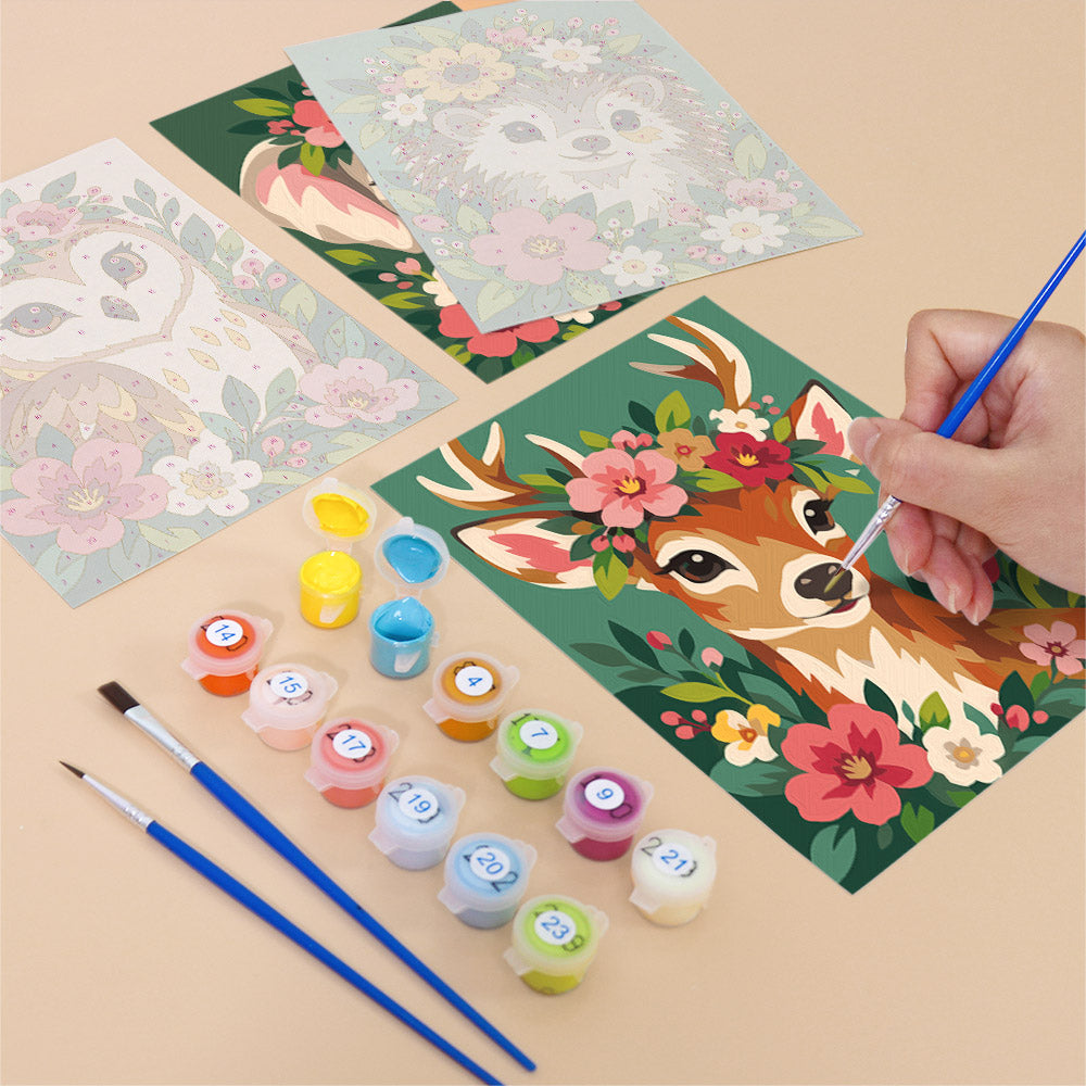 Filling in a Blossom Critters mini canvas with numbered acrylic paints and a fine brush
