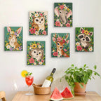 Six finished Blossom Critters mini paintings hung on a wall above a table