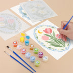Filling in a Blue Folk Florals mini canvas with numbered acrylic paints and a fine brush
