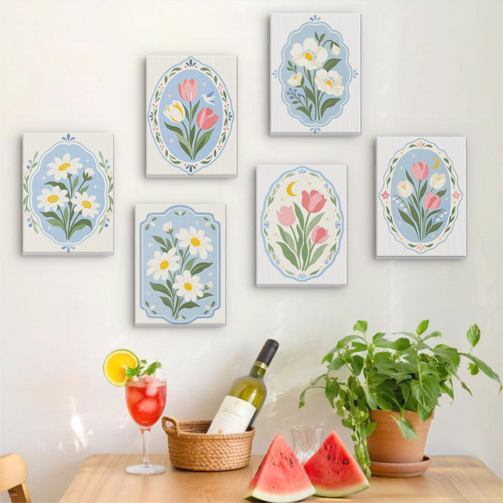Six finished Blue Folk Florals mini paintings hung on a wall above a table