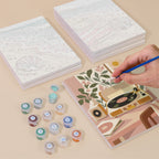 Painting one of the Blush Beach House designs next to a stack of mini canvases