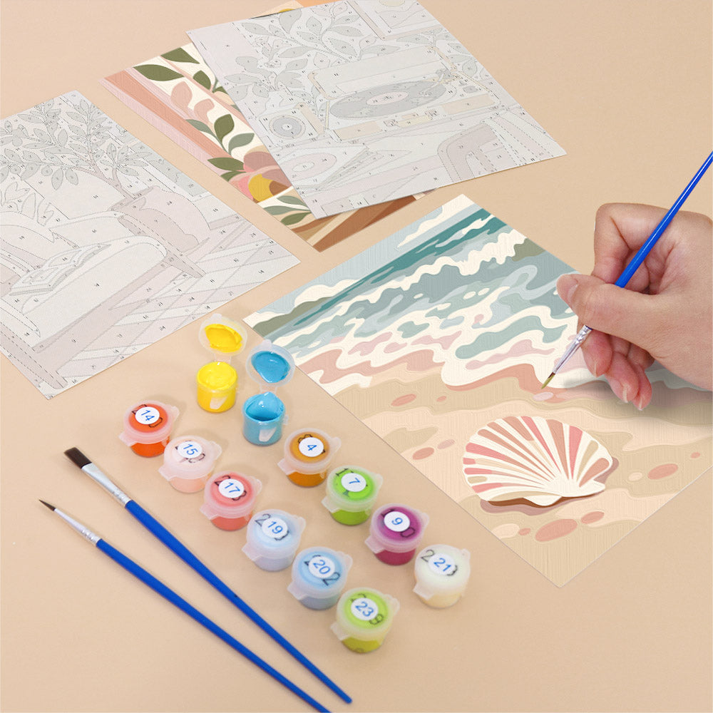 Filling in a Blush Beach House mini canvas with numbered acrylic paints and a fine brush