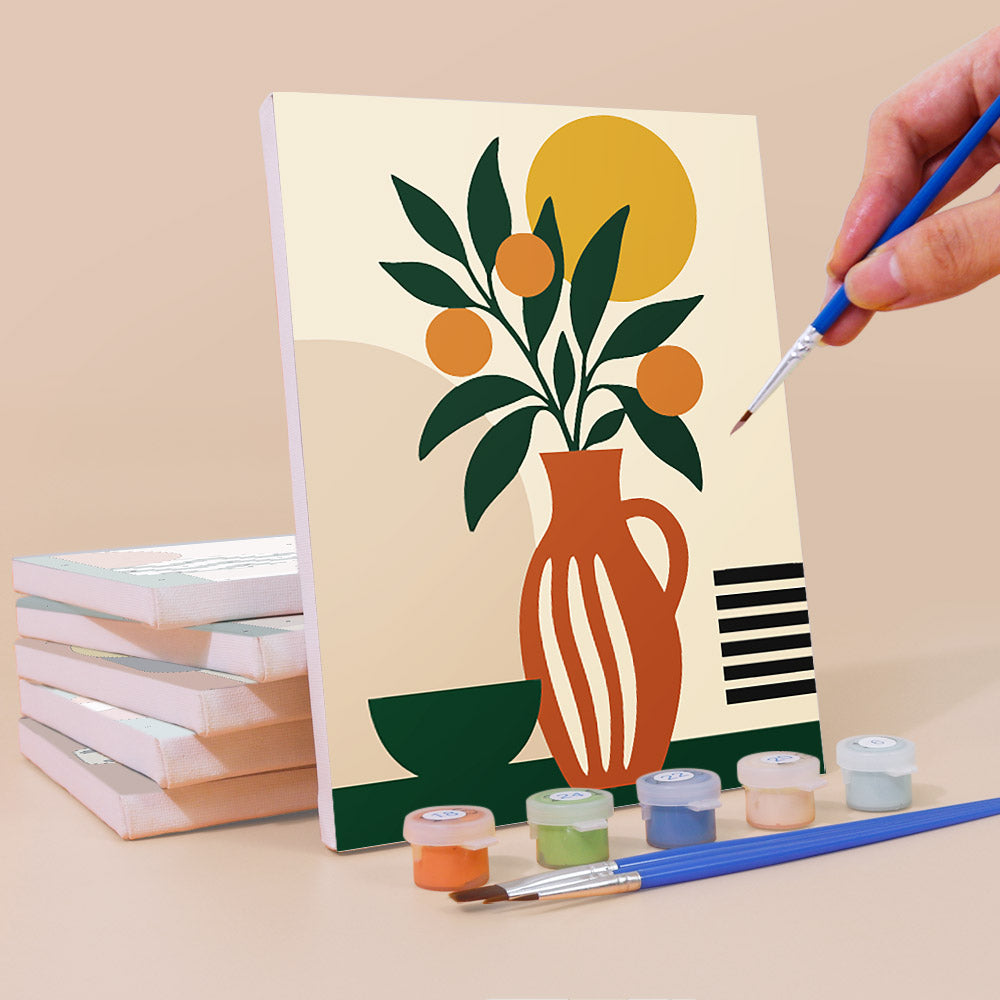 Painting a Boho Botanica mini canvas propped up beside numbered acrylic paints