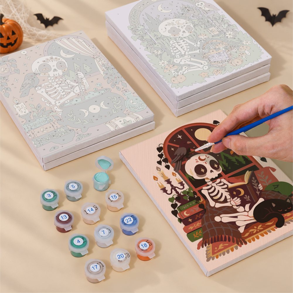 Painting one of the Boho Skeleton Hideaways designs next to a stack of mini canvases