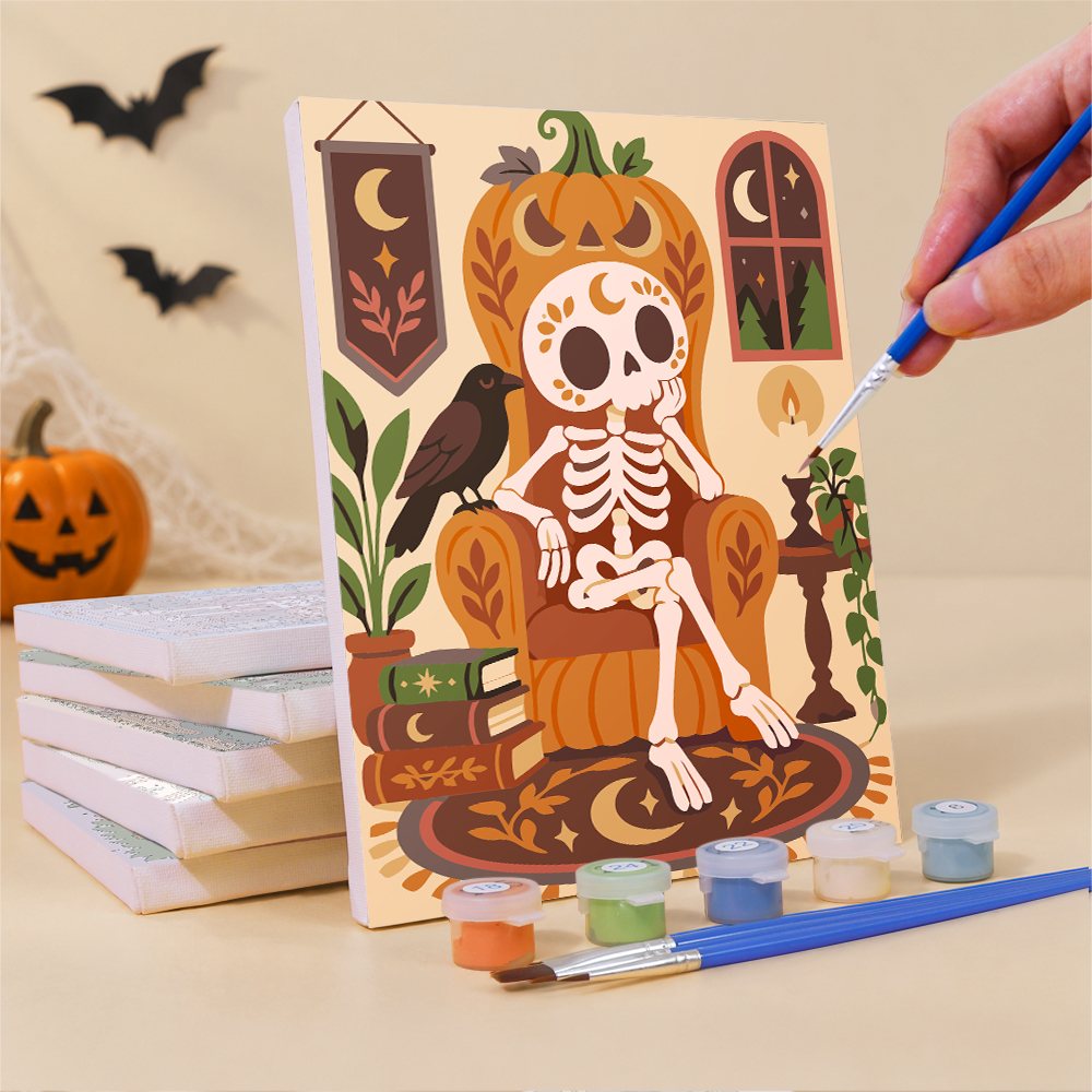 Painting a Boho Skeleton Hideaways mini canvas propped up beside numbered acrylic paints