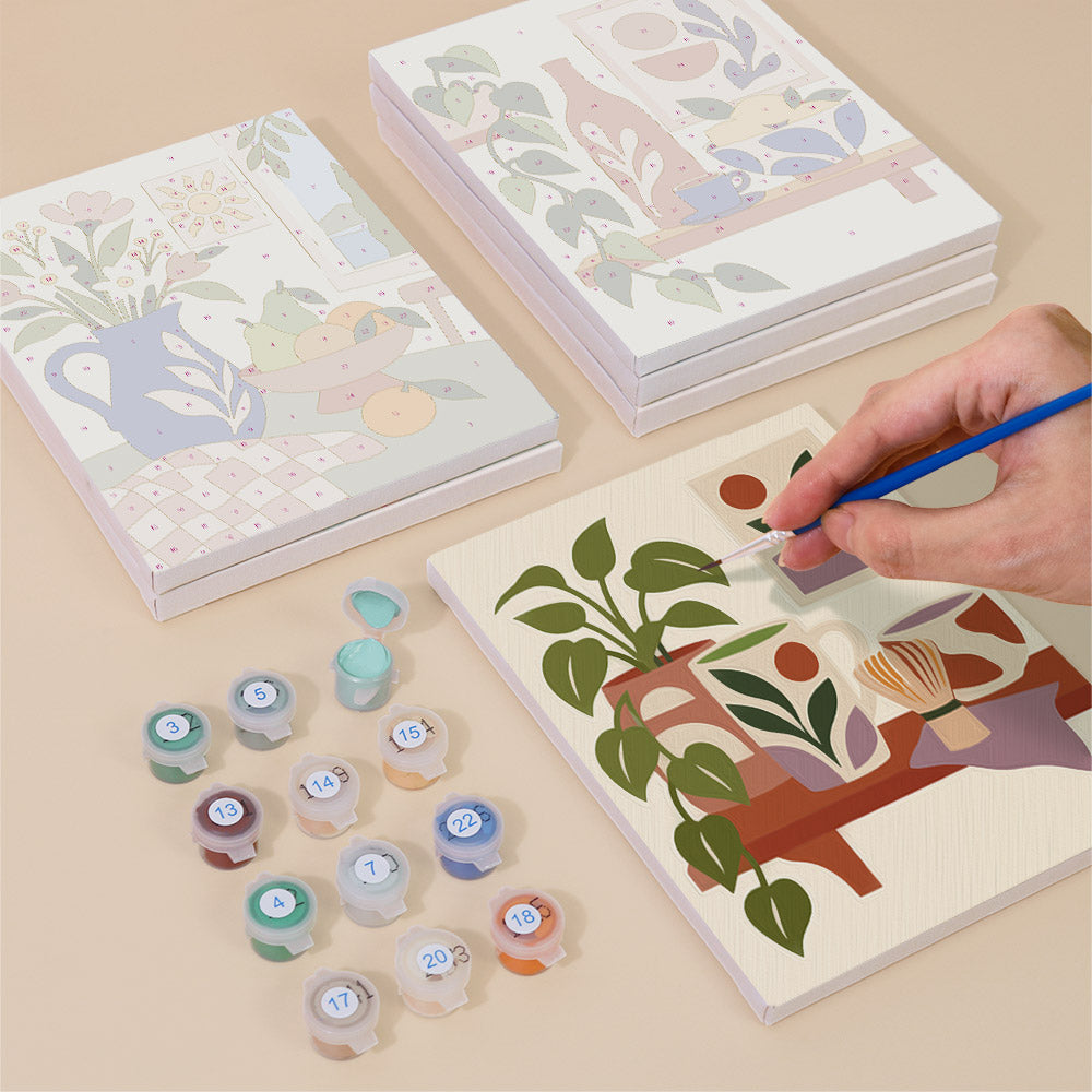 Painting one of the Boho Tea Time designs next to a stack of mini canvases