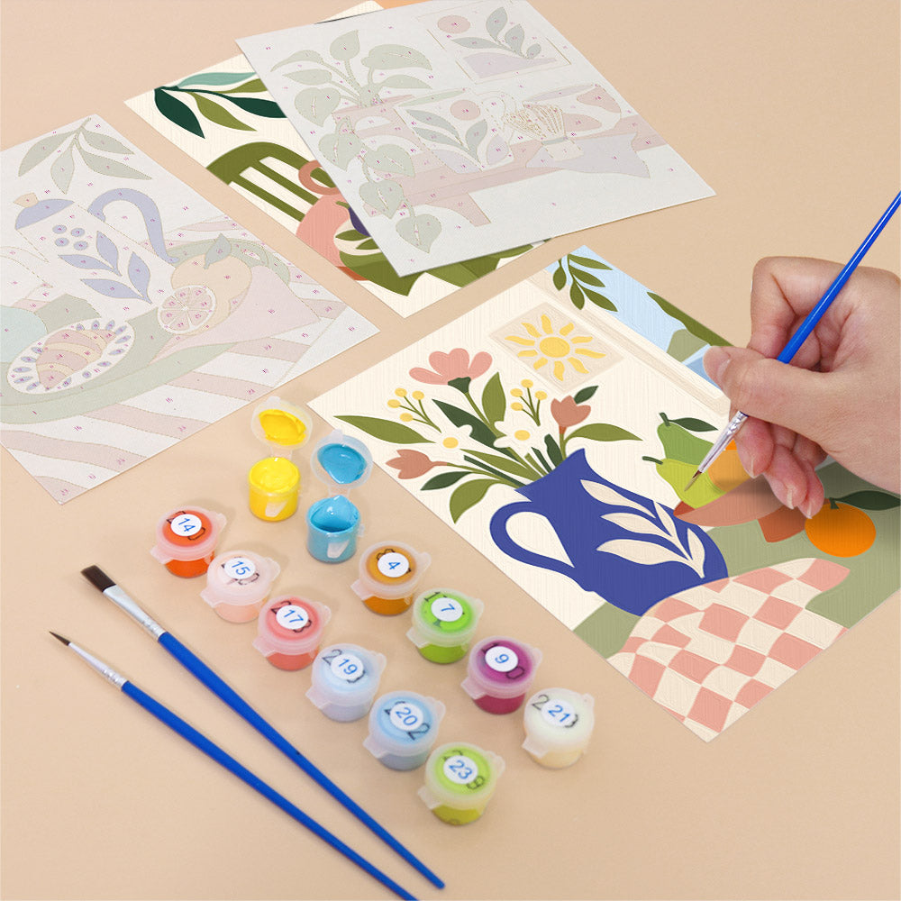 Filling in a Boho Tea Time mini canvas with numbered acrylic paints and a fine brush