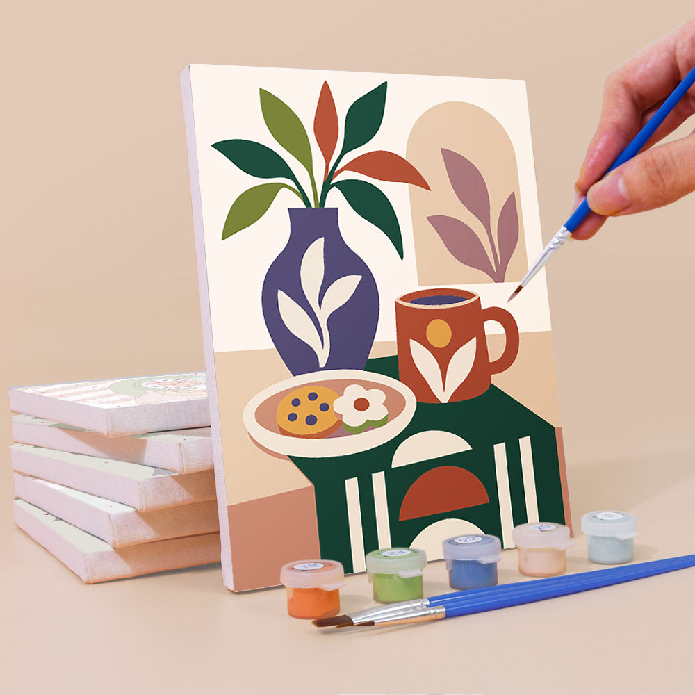 Painting a Boho Tea Time mini canvas propped up beside numbered acrylic paints