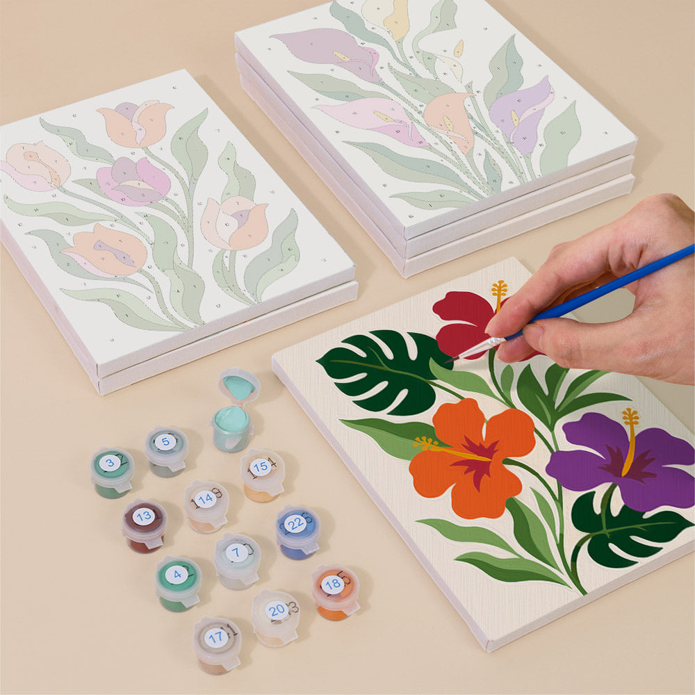 Painting one of the Bold Botanicals designs next to a stack of mini canvases