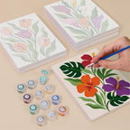 Painting one of the Bold Botanicals designs next to a stack of mini canvases